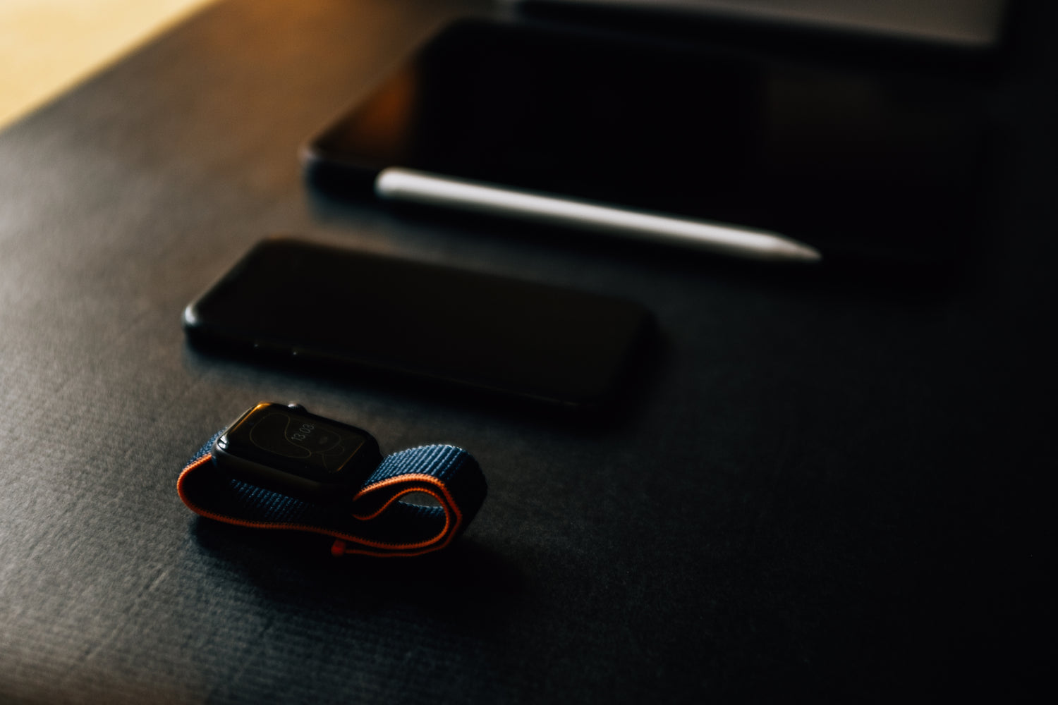 Fashion Watch Blog : black table with a smart watch cell phone and tablet